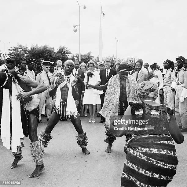 Attorney General Robert Kennedy, , and his wife, watch native dancers who greeted them upon their arrival here. Kennedy, the brother of the U. S....
