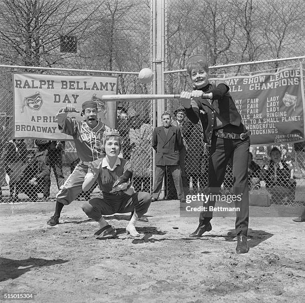 Lucille Ball takes her cut at the plate during the opening game of the Broadway baseball league in Central Park, April 20th. Catching, crown and all,...