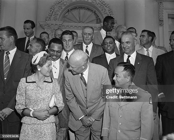 President Eisenhower is shown here chatting with Barbara Romack, one of America's leading golfers, as a group of the nation's outstanding sports...