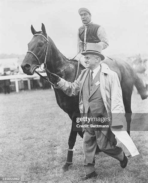 Jubilant Owner Leads Derby Winner After Race. Epsom Downs, England: Owner Pierre Wertheimer jubilantly leads in his French colt Lavandin, with jockey...