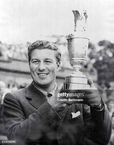 Thomson Takes British Open 3rd Time in Row. Holylake, England: Peter Thomson of Australia jubilantly holds his trophy after winning the British Open...