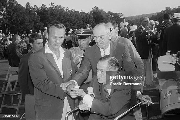 Augusta, Georgia: Masters tournament winners Arnold Palmer shows the ball he played to old master Bobby Jones, father of the classic golfing event,...