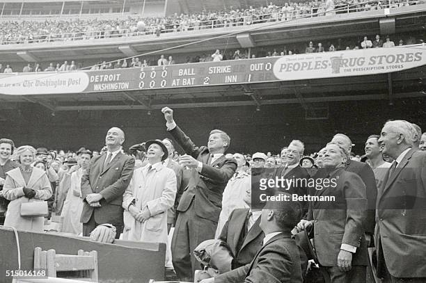 President Kennedy tosses out the first ball to officially open the 1962 baseball season here today. Left to right: Vice President Lyndon Johnson;...