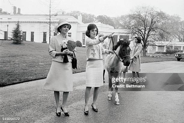 Mrs. Jacqueline Kennedy takes Empress Farah on a tour of the White House grounds today. The Empress is the wife of the Shah of Iran who is here on a...