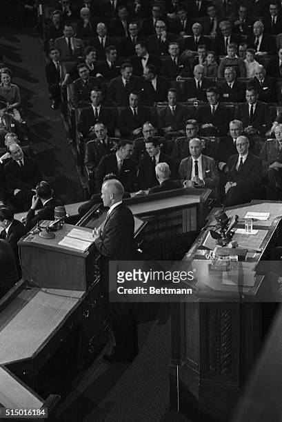 As his fellow astronauts look on Lt. Col. John H. Glenn speaks to a joint meeting of Congress, February 26th. The astronauts are Alan B. Shepard,...