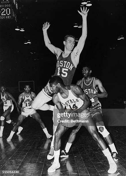 Boston Celtics beat the Cincinnati Royals tonight in an overtime game. Shown trying to get in for a shot is Oscar Robertson as Celtics' Tom Heinsohn...