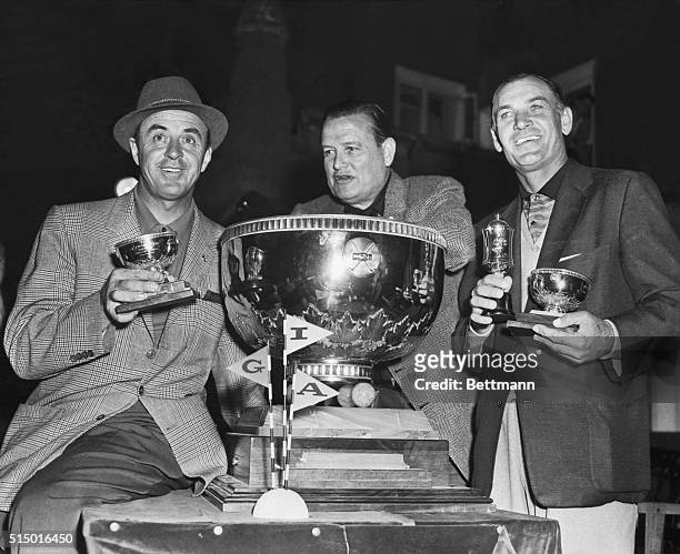 The American Canada Cup team of Sam Snead and Ben Hogan are seen receiving the huge Gold Canada Cup from the inaugurator, Mr. James Powell, at the...