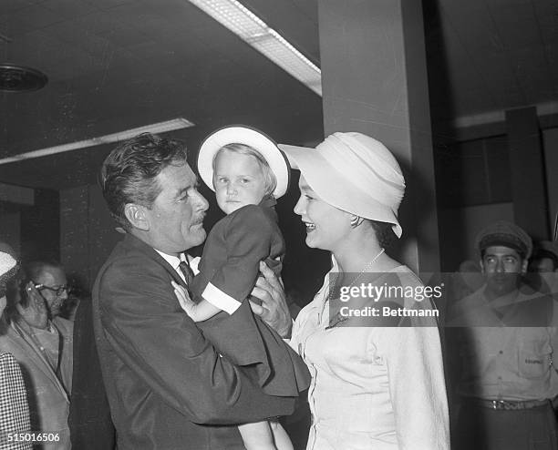 Reunion For Errol Flynn in Havana. Havana, Cuba: Actor Errol Flynn hugs his little daughter Arnella, 2 1/2 as his wife, Patrice Wymore watches in a...