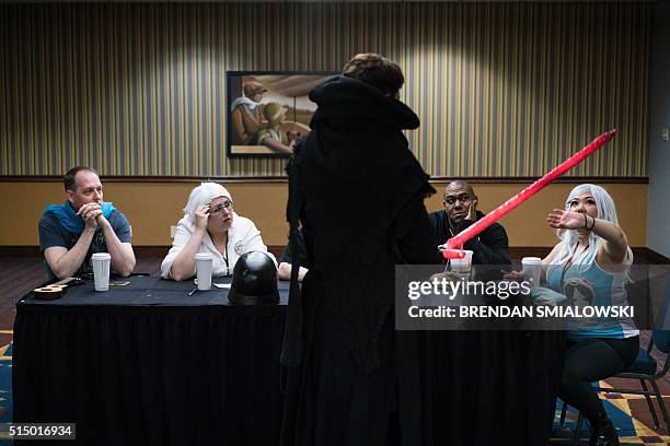 Berger, dressed as Star Wars character Kylo Ren, has his costume reviewed during the Cleveland Concoction March 11, 2016 in Cleveland, Ohio. / AFP /...