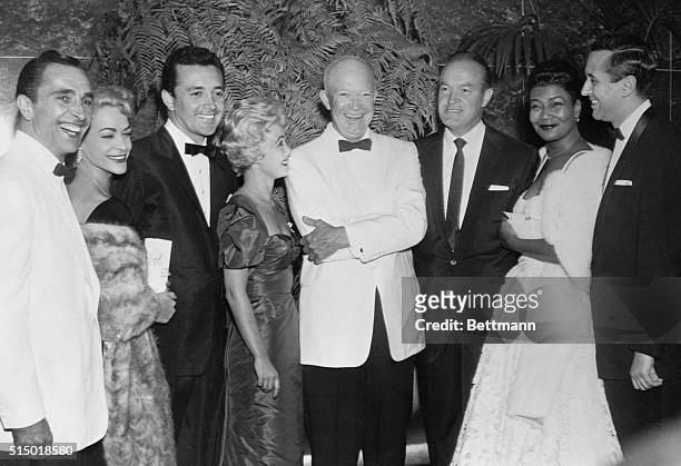 Gay evening before "stomach upset." Washington, D.C.: President Eisenhower was in a good mood, smiling and happy, when he posed with this group of...