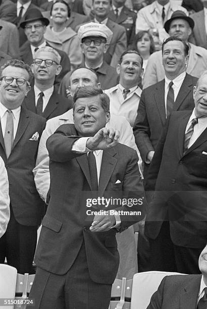 President Kennedy throws out the ball to officially open the 1962 baseball season here prior to the Washington-Detroit game, the first baseball game...