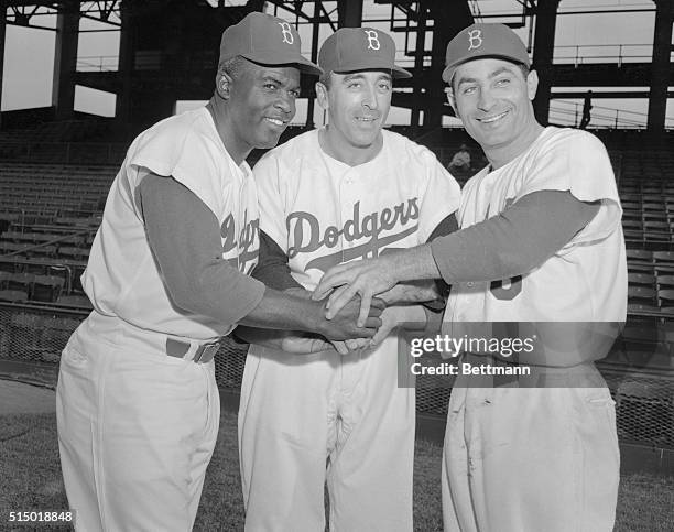 Former New York Giant and Cleveland Indian pitcher Sal Maglie , is welcomed to his new home, Ebbets Field, by Dodgers Jackie Robinson and Carl...