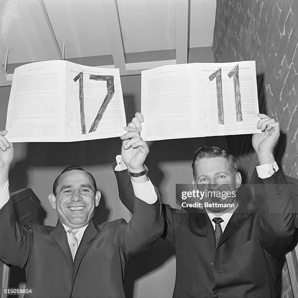 Veteran catcher and outfielder Yogi Berra and pitcher Whitey Ford hold up their 17th and 11th New York Yankee Baseball contracts, respectively,...