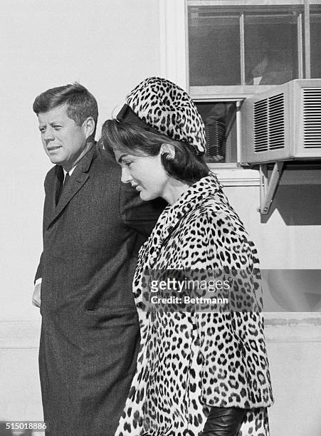 Middleburg, Va.: President and Mrs. Kennedy shown as they emerge from the Middleburg Community Center where they attended Mass. The President is...