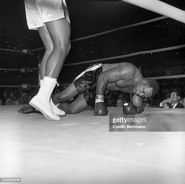 Los Angeles; Archie Moore hits the canvas in the fourth round here in one of three knockdowns that spelled his defeat by Cassius Clay. The...