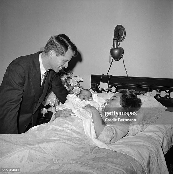 Robert Kennedy, Chief counsel of the Senate rackets committee, and Mrs. Kennedy are beaming fondly at their new baby, born thursday at Georgetown...