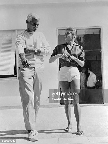 Actress Esther Williams takes a stroll with fellow actor Jeff Chandler after the day's work is done and they head for their dressing room.