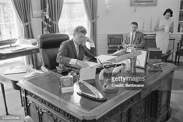 President John F. Kennedy speaks via telephone to the AMVETS convention in New York. Kennedy told the convention that the United States must maintain...