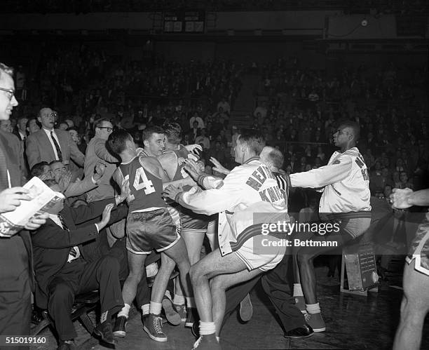 Battle royal broke out on the court at Madison Square Garden tonight when Richie Guerin of the Knicks and Bill Sharman of the Celtics got into a...