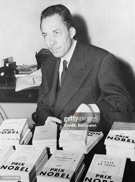 Albert Camus, French Existentialist author and playwirhgt, pictured at a book signing after recently being awarded the Nobel Prize for Literature.