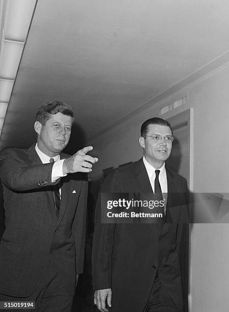 President Kennedy gestures as he walks through the corridors of the Pentagon today during a visit with Secretary of Defense Robert S. McNamara . The...