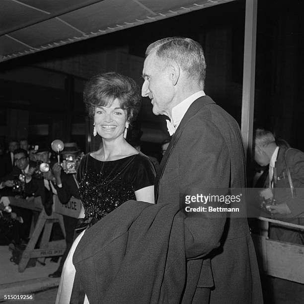 Accompanied by John D. Rockefeller III, Board Chairman of Lincoln Center, Mrs. Jacqueline Kennedy arrives for the premiere performance at the brand...