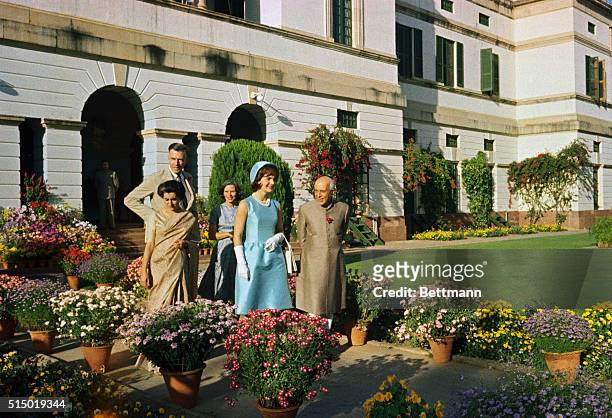 Jacqueline Kennedy and Prime Minister Nehru walk through the gardens of the Presidential Palace in New Delhi.