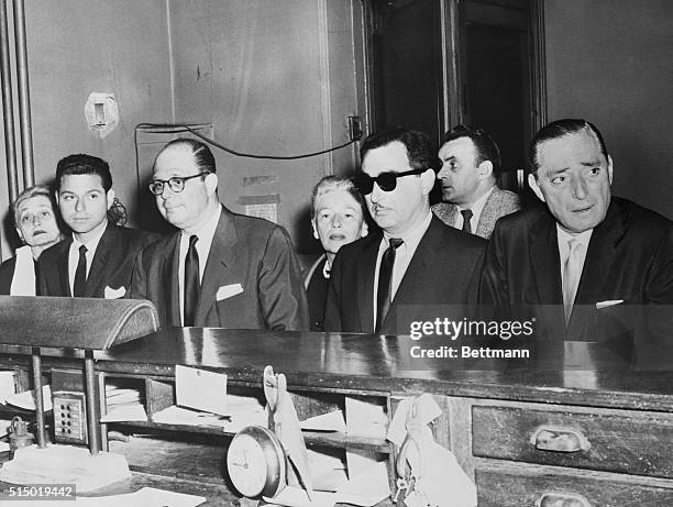 New York, New York: In Elizabeth street police station, Robert Harrison, publisher of Confidential magazine and five associates are shown as they...