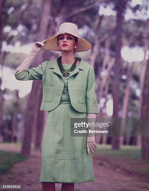 Florence, Italy: Decorative seaming marks a green linen ensemble from the Spring collection of Princess Irene Galitzine of Italy. The short, curving...