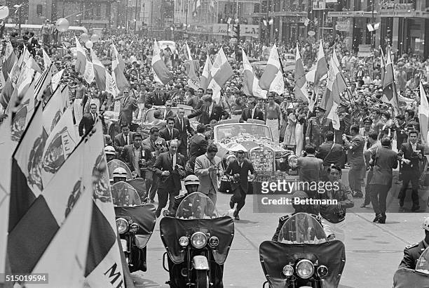 Mexico City: President John F. Kennedy and Mexican President Lopez Mateos parade down flag lined streets through Mexico City.