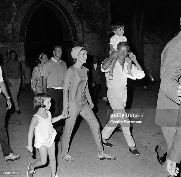 Mrs. Jacqueline Kennedy holds the hand of her daughter, Caroline, while Gilbert Graziana, a friend, carries her nephew, Anthony Radziwill, and her...