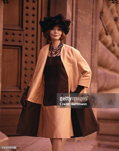 Florence, Italy: High fashion wears an apron in the afternoon as Marucelli of Milan sets an apron-like black panel on the front of an unbelted dress...