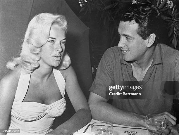 British film actress Diana Dors seems to have hypnotized Rock Hudson, who has no eyes for anything else but Diana as she visited him on the movie set...