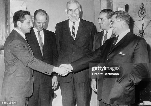 Jim Lee Howell director of personnel, New York Giants and former head coach of the Giants, greets (L0 Al Sherman head coach New York Giants; Tom...