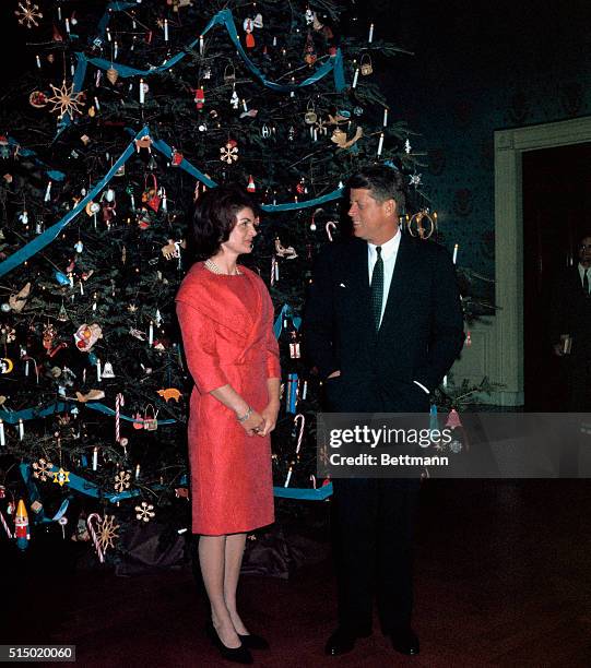 Washington, D. C.: president John F. Kennedy with wife posed before the White House Christmas tree,