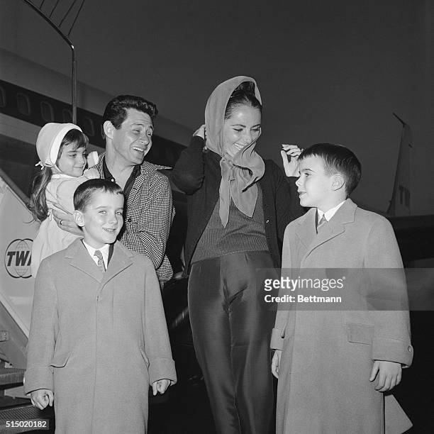Los Angeles, California: Actress Elizabeth Taylor, still recovering from her near-fatal illness, greets her three children at the airport with her...
