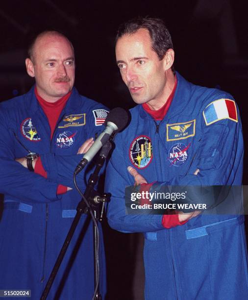 Space Shuttle Discovery French Mission Specialist Jean-Francois Clervoy talks to the media 06 December 1999 as US Pilot Scott Kelly listens upon...