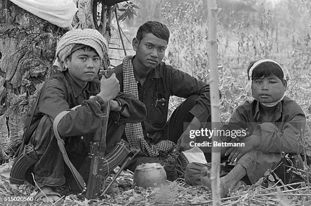 Khmer Rouge soldiers rest in last ditch defensive position a half mile from the Thai border. Soldier with white bandage has infected shrapnel wound...