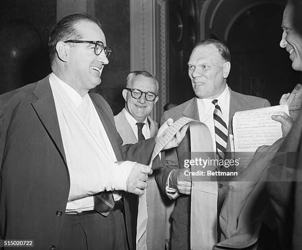 Senator Joe pleased at sample of "Ten Million" petitions. Washington, D.C.: Senator Joseph McCarthy, Wisconsin, flashed a pleased grin as he examined...