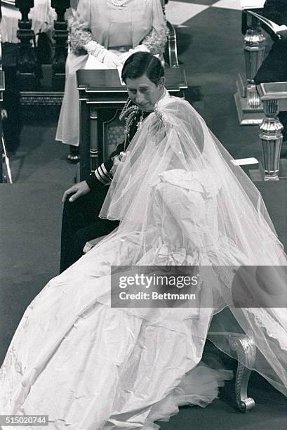 Photo shows Diana Spencer and Prince Charles during their wedding ceremony. Here Charles is looking at his bride to be.