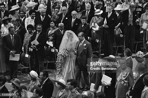 Earl Spencer is shown walking his daughter, Diana Spencer down the aisle during her wedding ceremony.