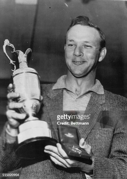 Winner in British Golf Open. Southport, England: American golfer Arnold Palmer holds his trophy here after winning the British Open Golf Championship...