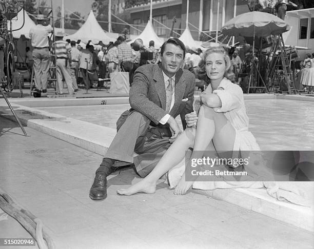 Gregory Peck and Lauren Bacall on the set of the MGM picture Designing Woman on the first day of shooting at the Beverly Hills Hotel.