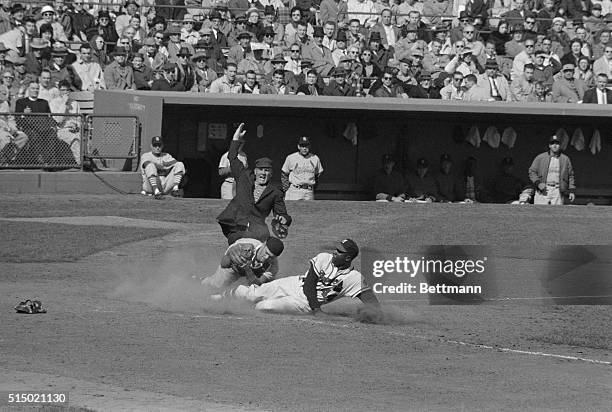 Milwaukee Braves right fielder Hank Aaron is out at the plate when he attempted to score from third after Braves 2nd baseman Frank Bolling hit to...