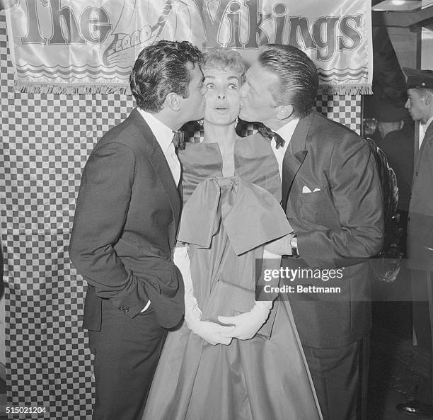 Caught in a two-way smackup, Janet Leigh get plenty of lip from husband Tony Curtis and Kirk Douglas. The three stars smooched while making personal...