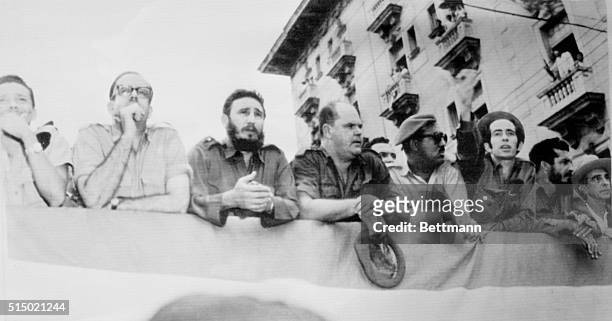Cuban Premier Fidel Castro and other government officials watch the funeral procession of seven victims of the early-morning air attack on the Havana...