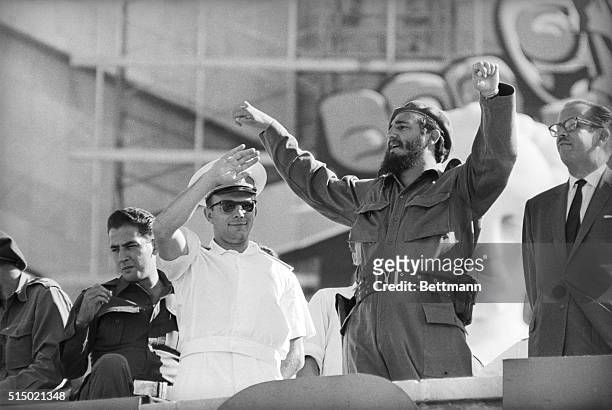 Cuban Premier Fidel Castro and Soviet Spaceman Yuri Gagarin wave to cheering Cubans during celebration on the eighth anniversary of Castro's...