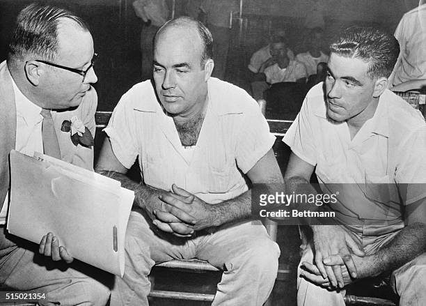 Milam of Glendora, Miss., and his half brother, Roy Bryant of Money, Miss., shown here conferring with an attorney, Sidney Carlton in the courthouse...