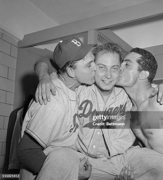 Johnny Podres, Dodger pitcher who toppled the mighty Yankees today to win the first World Series Championship for the Flatbushers, is kissed on the...