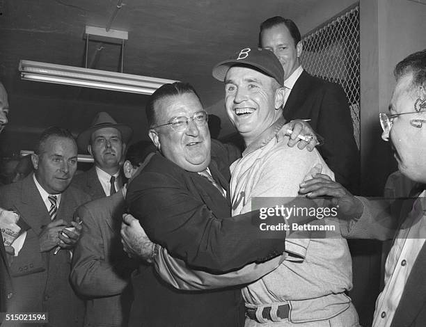 Deserving Hug from the Big Boss. New York, New York: Walter O'Malley, left, president of the Brooklyn Dodgers, the 1955 World Champions, gives...
